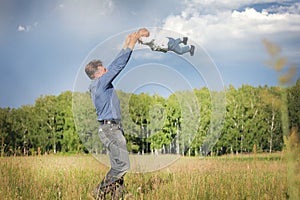 Dad and son frolic in the clearing.