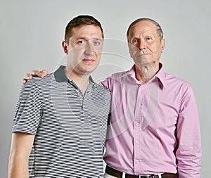 Dad and son on grey background