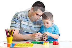 Dad and son handworking at table