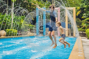 Dad and son have fun in the pool