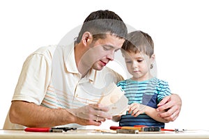 Dad and son kid teach building nesting box