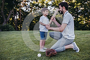 Dad with son playing baseball