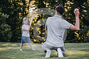 Dad with son playing baseball