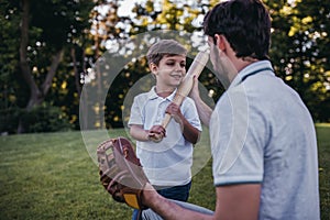 Dad with son playing baseball