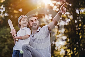 Dad with son playing baseball