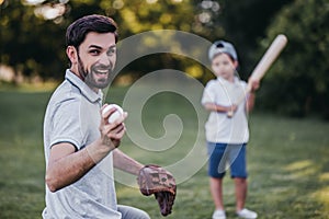 Dad with son playing baseball