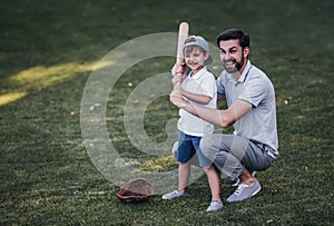 Dad with son playing baseball