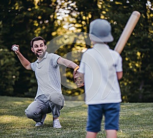 Dad with son playing baseball