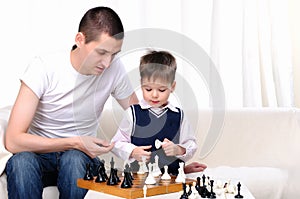 Dad and son playing chess
