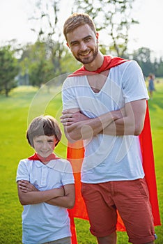 Dad and son playing superheroes