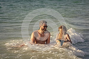 dad and son playing together. happy moments with father and son. Father son beach adventure playing with toy ship