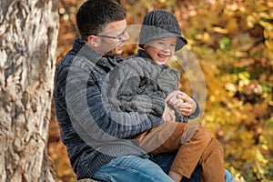 Dad and son playing together outdoors in the park