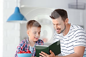 Dad and son reading interesting book