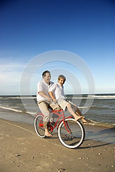 Dad and son riding bicycle