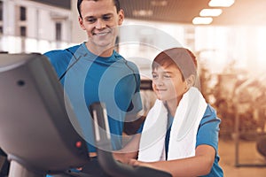 Dad and son in the same clothes in gym. Father and son lead a healthy lifestyle.