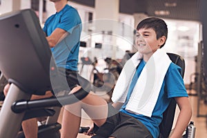 Dad and son in the same clothes in gym. Father and son lead a healthy lifestyle.