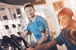 Dad and son in the same clothes in gym. Father and son lead a healthy lifestyle.