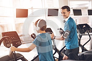 Dad and son in the same clothes in gym. Father and son lead a healthy lifestyle.