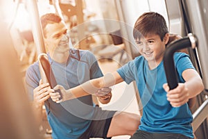 Dad and son in the same clothes in gym. Father and son lead a healthy lifestyle.