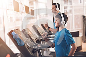 Dad and son in the same clothes in gym. Father and son lead a healthy lifestyle.