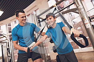 Dad and son in the same clothes in gym. Father and son lead a healthy lifestyle.