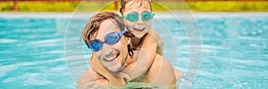 Dad and son in swimming Goggles have fun in the pool BANNER, LONG FORMAT