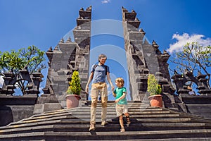 Dad and son tourists in budhist temple Brahma Vihara Arama Banjar Bali, Indonesia. Honeymoon