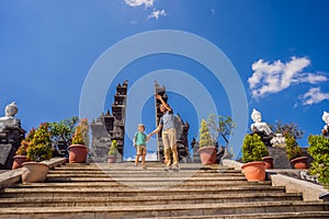 Dad and son tourists in budhist temple Brahma Vihara Arama Banjar Bali, Indonesia. Honeymoon