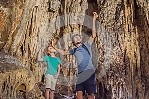 Dad and son tourists in Hang Sung Sot Grotto Cave of Surprises, Halong Bay, Vietnam. Traveling with children concept