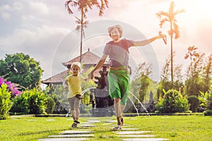 Dad and son tourists in Traditional balinese hindu Temple Taman Ayun in Mengwi. Bali, Indonesia. Traveling with children concept w