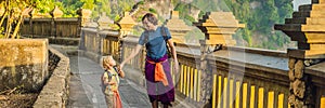 Dad and son travelers in Pura Luhur Uluwatu temple, Bali, Indonesia. Amazing landscape - cliff with blue sky and sea