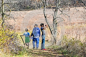 Dad and Sons Hiking through Nature Preserve