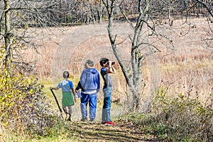 Dad and Sons Hiking through Nature Preserve photo