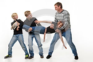 Dad and sons stretch sister by the arms and legs, white background