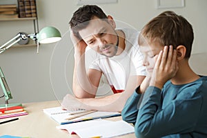Dad struggling to help his son with school assignment