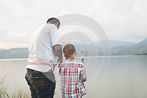 Dad teach his son fishing