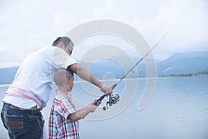 Dad teach his son fishing