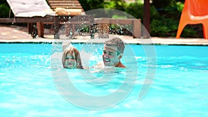 dad teaches his daughter to swim in the pool. games and activities in the water.