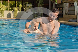 Dad teaches his son to swim