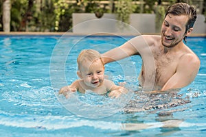 Dad teaches his son to swim