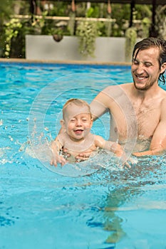 Dad teaches his son to swim