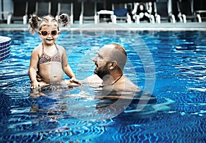 Dad teaches a little daughter to swim