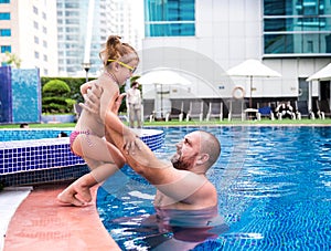 Dad teaches a little daughter to swim