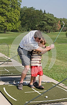 Dad Teaching Son Golf