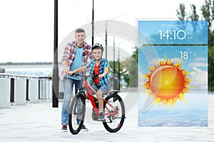 Dad teaching son to ride bicycle and weather forecast widget. Mobile application