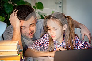 Dad tired helps daughter online lessons on laptop