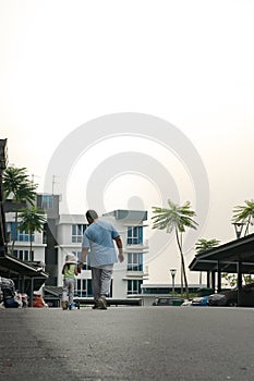 Dad walks with her daughter in the neighbourhood.