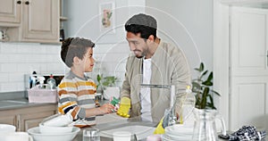 Dad washing dishes, teaching kid and cleaning with soap, water and sponge in the kitchen, family home and boy learning