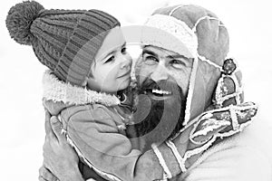 Daddy and boy smiling and hugging. Happy family son hugs his dad on winter holiday.