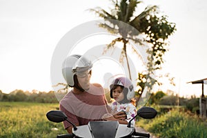 Daddy with daughter on motorcycle scooter